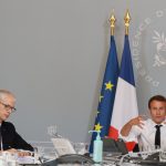 French President Emmanuel Macron and Culture Minister Franck Riester (L) take part in a videoconference with artists from different fields at the Elysee Palace in Paris on May 6, 2020 before announcing the first orientations of a "culture plan" as France is under a strict lockdown to stop the spread of the Covid-19 pandemic caused by the novel coronavirus. (Photo by Ludovic MARIN / POOL / AFP)